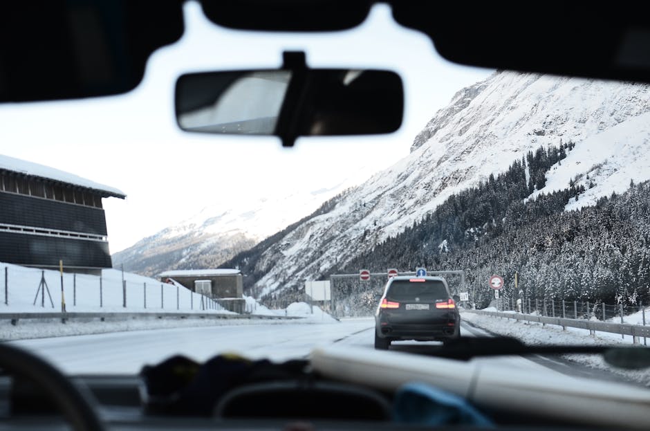 Experience a scenic winter drive through snow-covered Swiss Alps with breathtaking mountain views.
